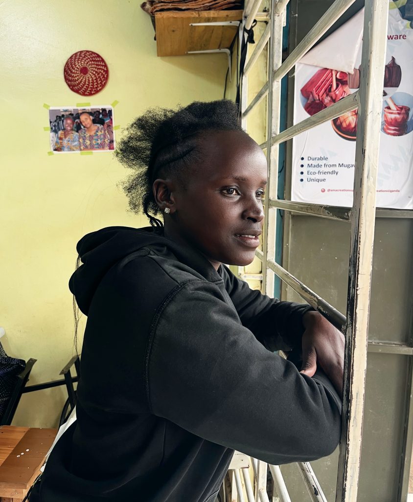 Sharon Nalwenge gazing outside her shop in Namugongo. © Rodney Muhumuza for TWR