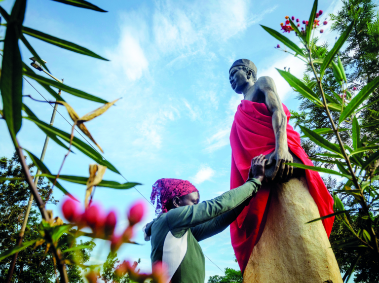 A pilgrim holds onto the statue of a saint while immersed in deep prayer at Namugongo, an area just outside Kampala where pilgrims converge around the Basilica of Uganda Martyrs. The annual pilgrimage has long been a mark of faith for tens of thousands of people who trek there. © Badru Katumba for TWR