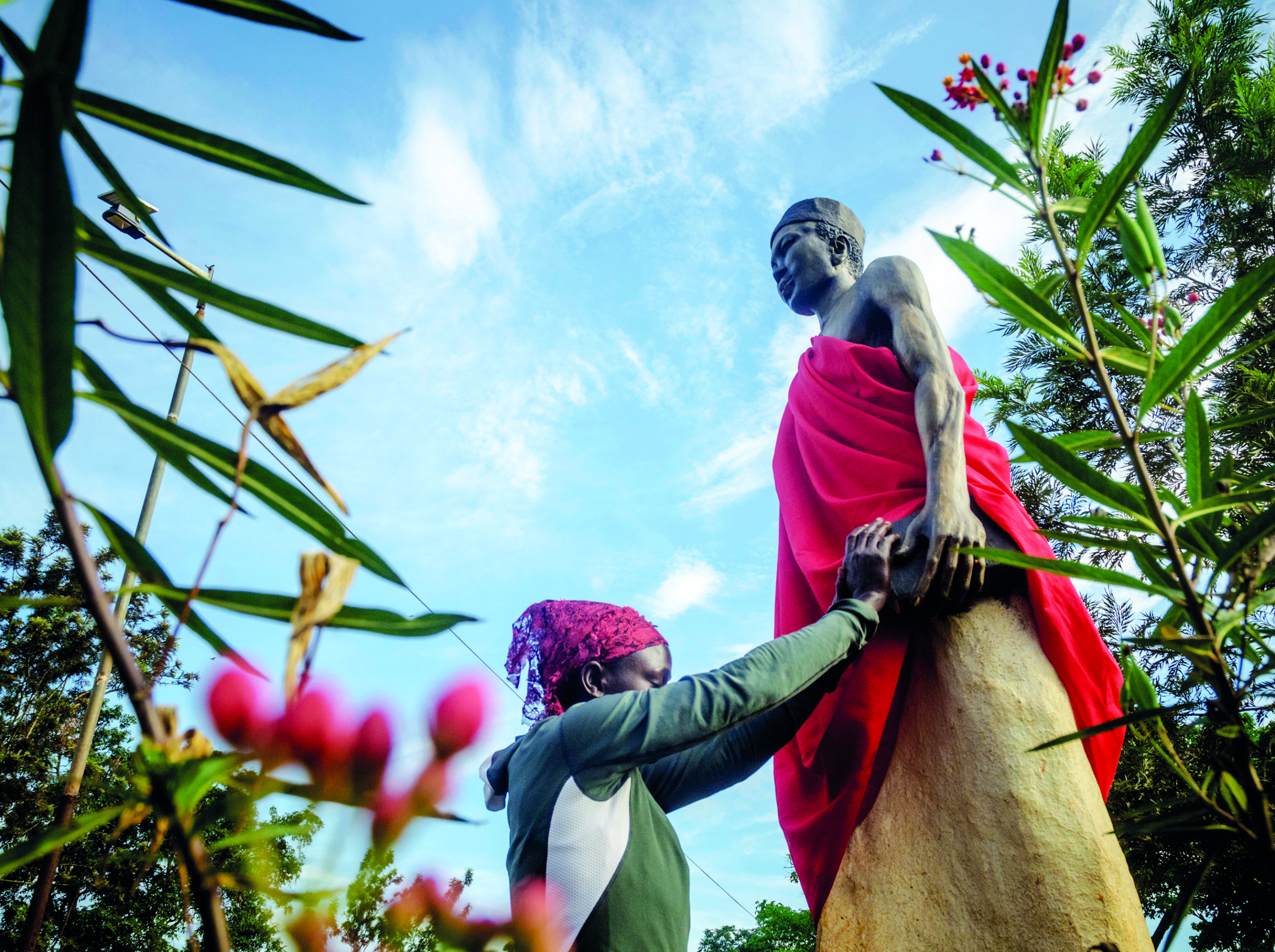 A pilgrim holds onto the statue of a saint while immersed in deep prayer at Namugongo, an area just outside Kampala where pilgrims converge around the Basilica of Uganda Martyrs. The annual pilgrimage has long been a mark of faith for tens of thousands of people who trek there. © Badru Katumba for TWR