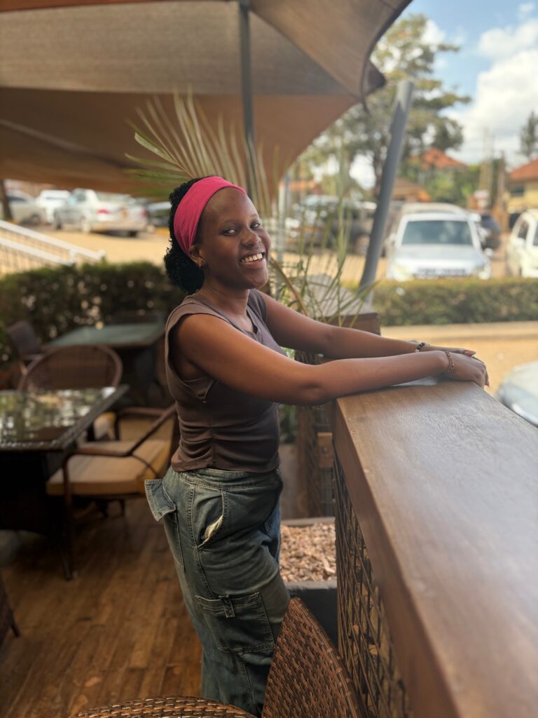 40. Photo of a Smiling Woman at an Outdoor Cafe Counter The Weganda Review Issue 13 40. Photo of a Smiling Woman at an Outdoor Cafe Counter The Weganda Review Issue 13